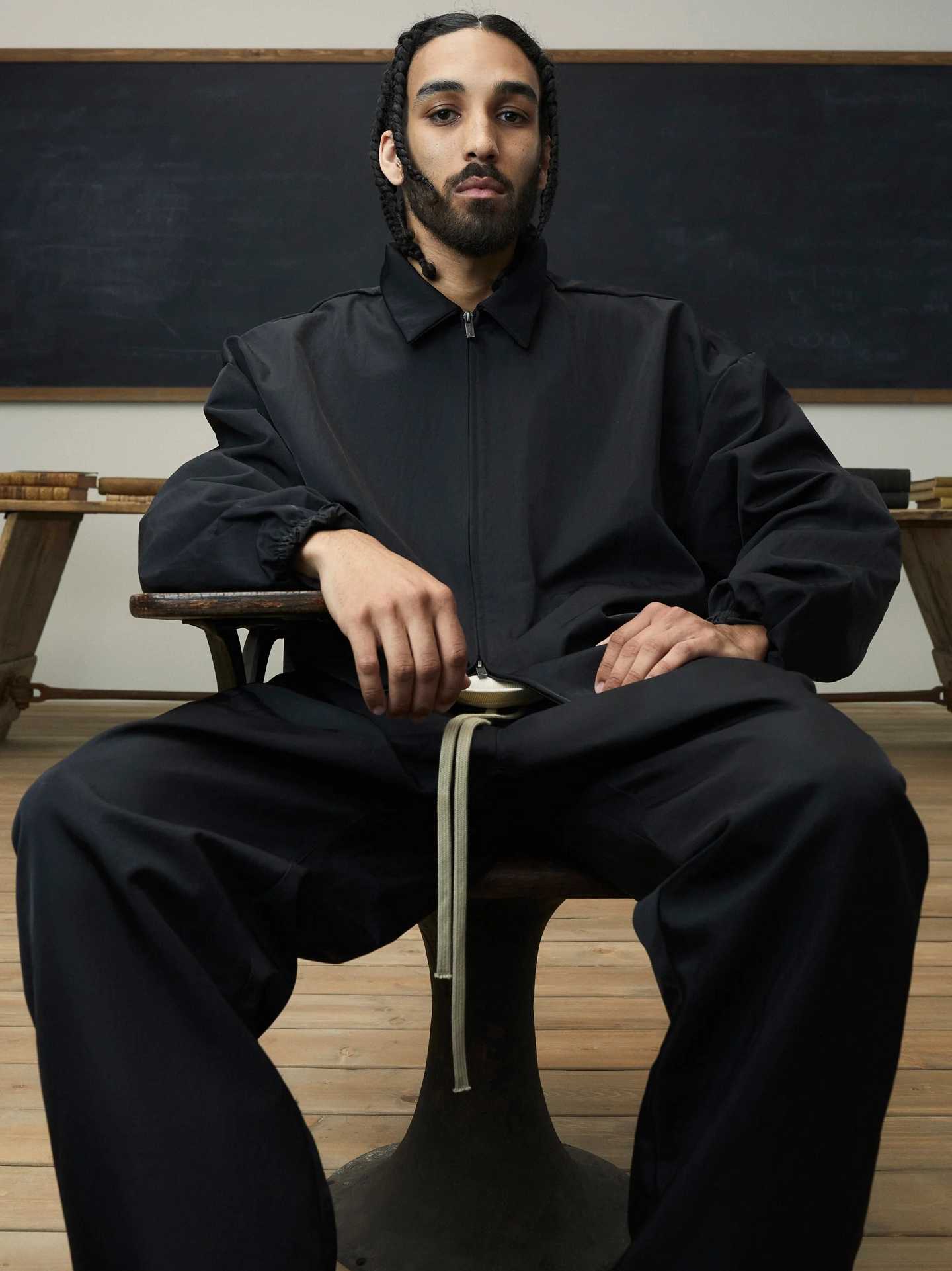 FEAR OF GOD ESSENTIALS 24FW stand collar windbreaker with appliqué letter embroidery.